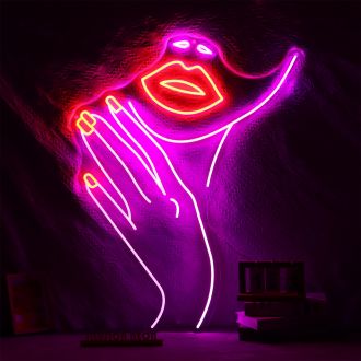 The Nails neon sign is a vibrant and eye-catching display that features the silhouette of a woman's face with long and a pair of brightly glowing nails. 