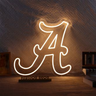 The Alabama Crimson Tide neon sign is a vibrant and striking display that showcases the team's signature colors of orange. The bold, orange neon lights illuminate the letters of the team's name, which is surrounded by a glowing white outline. The sign is 