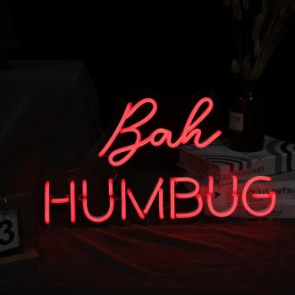 The Bah Humbug neon sign is a bright and bold display of holiday grumpiness. The bright red letters of "Bah Humbug" are illuminated against a black background, making the message of Scrooge-like sentiments stand out against any holiday cheer. This neon si