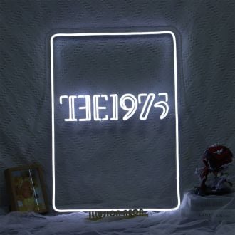 The 1975 neon sign is a white glowing sign that features the band's name in bold, capital letters. The sign has a sleek, modern design with smooth edges and clean lines. The white neon lights up the letters, giving off a cool, futuristic vibe. The sign is